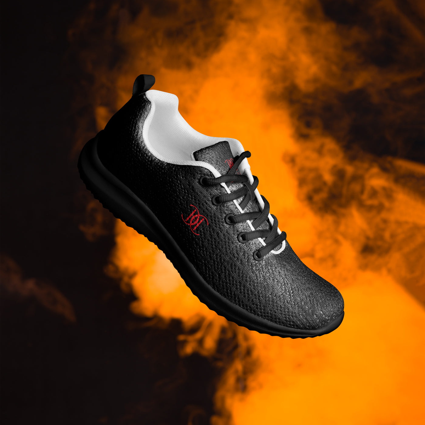 Black athletic sneaker with textured finish, red Cachy’s Urban logo, and white inner lining, showcased on a fiery orange smoke background