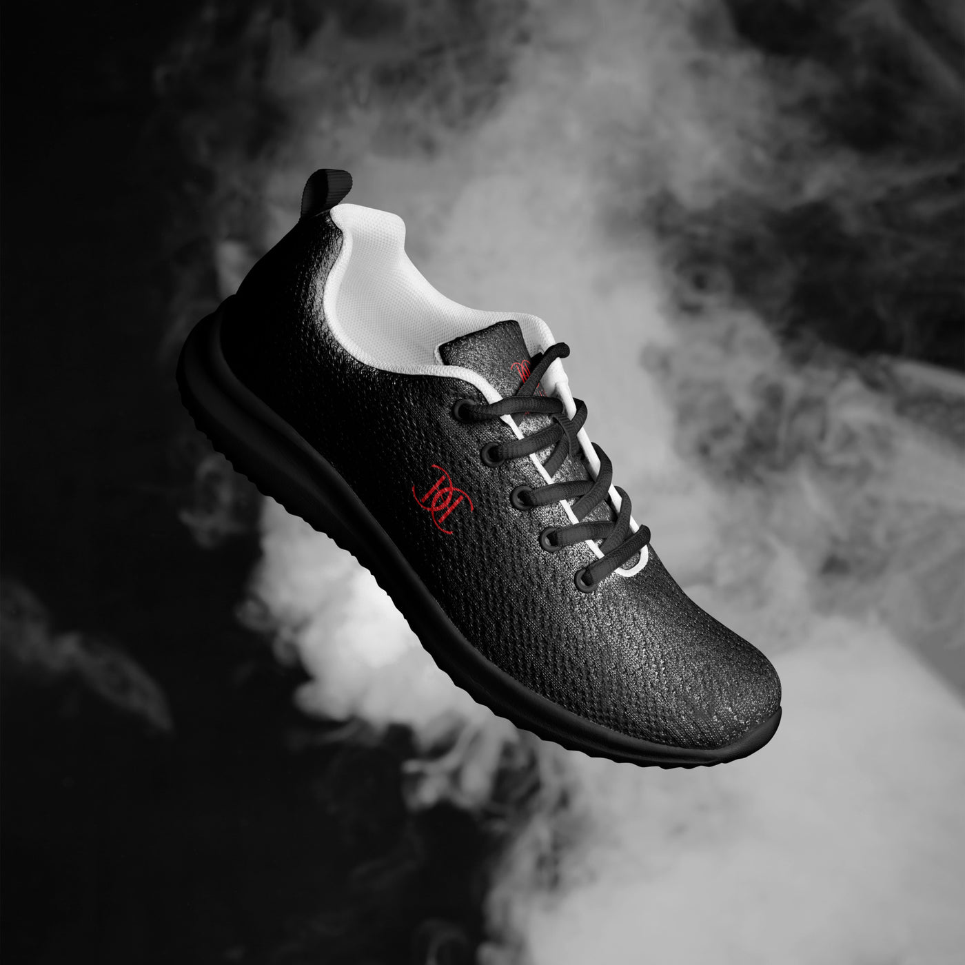 Black athletic sneaker with textured finish, red Cachy’s Urban logo, and white inner lining, showcased on a fiery orange smoke background