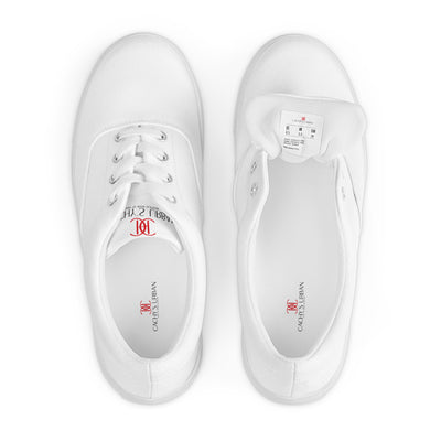 All-white lace-up canvas sneakers with minimalist design and subtle red Cachy’s Urban branding on the tongue