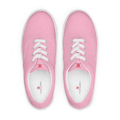Bright pink lace-up canvas sneakers with white laces, white soles, and Cachy’s Urban branded insoles