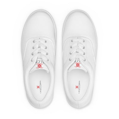 All-white lace-up canvas sneakers with minimalist design and subtle red Cachy’s Urban branding on the tongue
