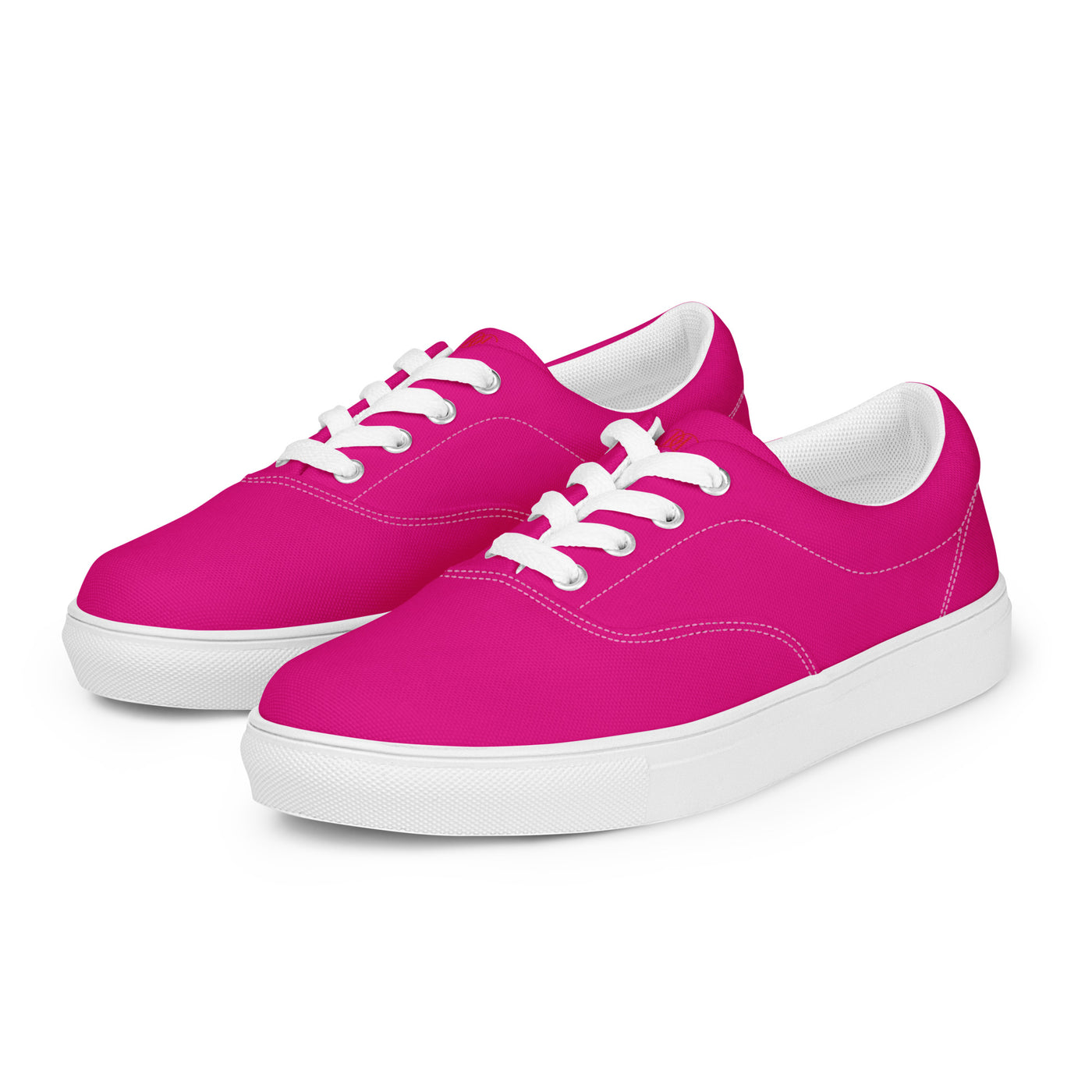 Bright pink lace-up canvas sneakers with white laces, white soles, and Cachy’s Urban branded insoles