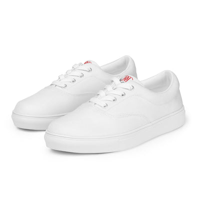 All-white lace-up canvas sneakers with minimalist design and subtle red Cachy’s Urban branding on the tongue
