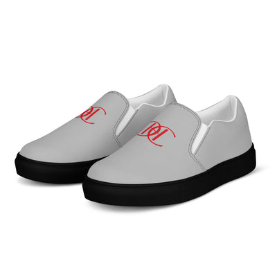 Grey slip-on sneakers with black soles, featuring bold red Cachy’s Urban logo on the front and branded insoles