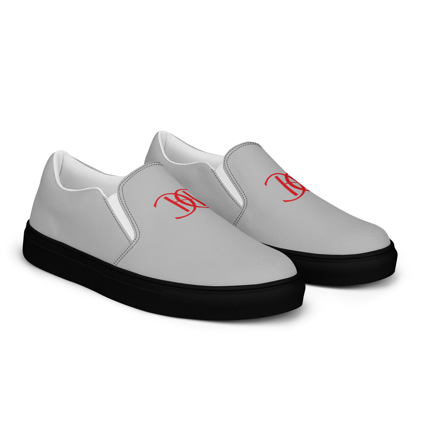 Grey slip-on sneakers with black soles, featuring bold red Cachy’s Urban logo on the front and branded insoles