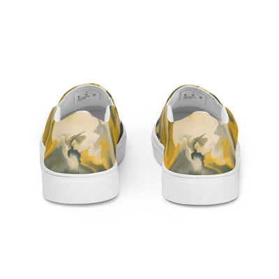 Slip-on canvas shoes with abstract camouflage pattern in yellow, green, and gray tones, featuring Cachy’s Urban branding on the insoles