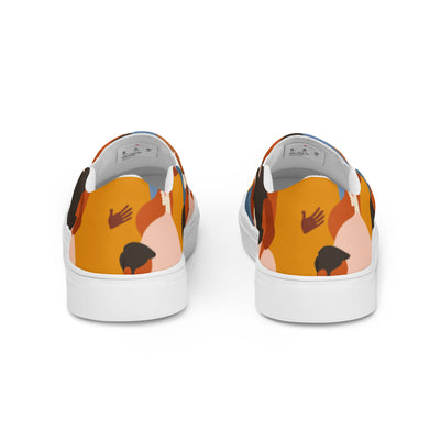 Slip-on canvas shoes with tribal-style multicolor abstract pattern featuring diverse human silhouettes in earthy tones and Cachy’s Urban branded insoles