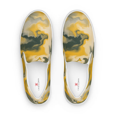 Slip-on canvas shoes with abstract camouflage pattern in yellow, green, and gray tones, featuring Cachy’s Urban branding on the insoles