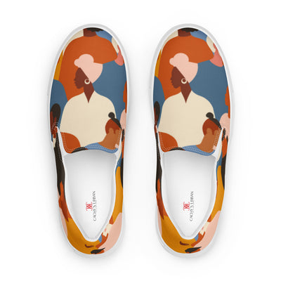 Slip-on canvas shoes with tribal-style multicolor abstract pattern featuring diverse human silhouettes in earthy tones and Cachy’s Urban branded insoles