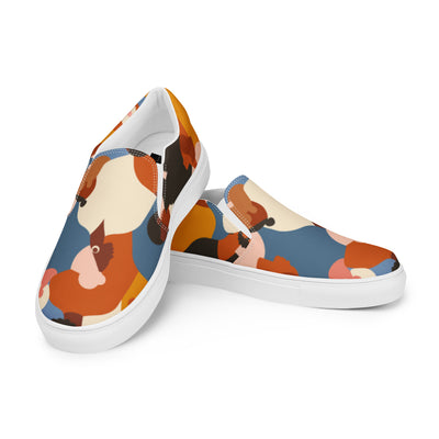 Cachy’s Urban slip-on sneakers with a tribal-inspired multicolor print (orange, blue, beige, and brown tones) on a white sole