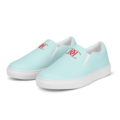 Light blue slip-on canvas shoes with red Cachy’s Urban monogram logo on the upper front and branded insoles