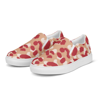 Beige slip-on canvas shoes with bold red and cream abstract leopard print pattern, featuring Cachy’s Urban branded insoles