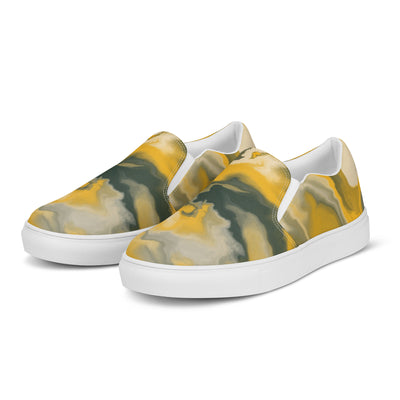 Slip-on canvas shoes with abstract camouflage pattern in yellow, green, and gray tones, featuring Cachy’s Urban branding on the insoles