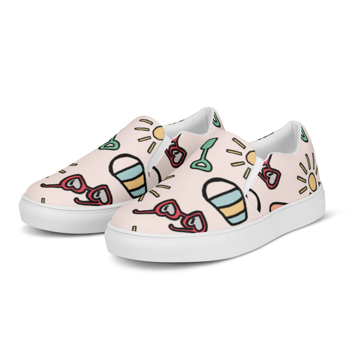Pink slip-on canvas shoes with playful summer icons featuring suns, sunglasses, and shovels in a cartoon style