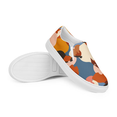 Cachy’s Urban slip-on sneakers with a tribal-inspired multicolor print (orange, blue, beige, and brown tones) on a white sole