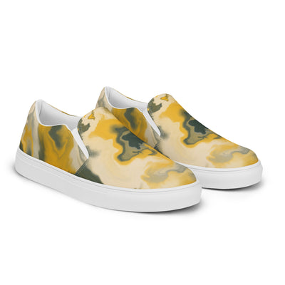 Slip-on canvas shoes with abstract camouflage pattern in yellow, green, and gray tones, featuring Cachy’s Urban branding on the insoles