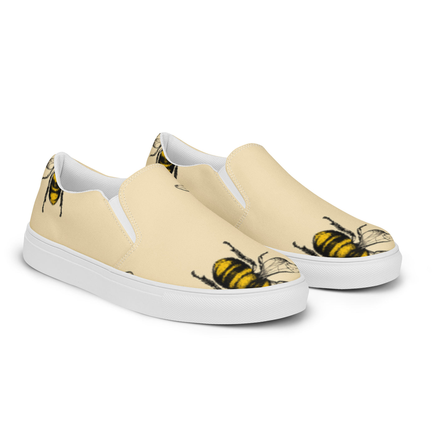 Beige slip-on canvas shoes with a bold bee pattern design and Cachy’s Urban branded insoles
